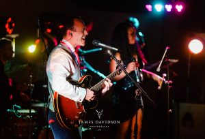 festival wedding groom singing guitar